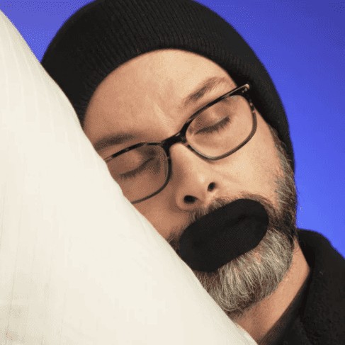 Snoring man with mouth tape